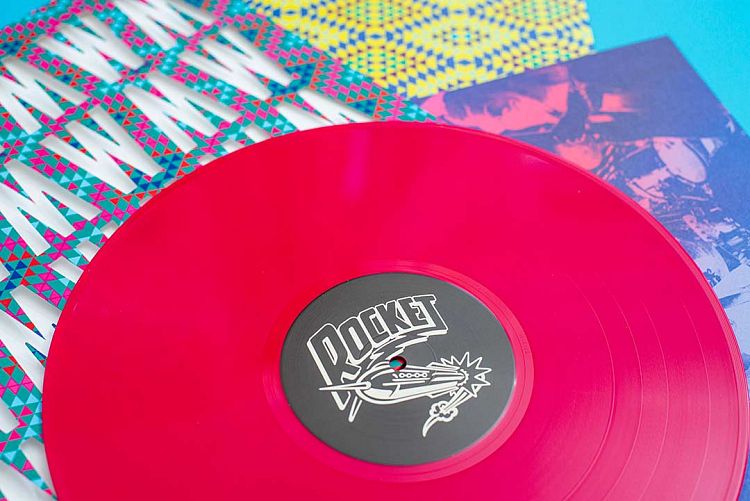 Red vinyl record in custom die cut sleeve.