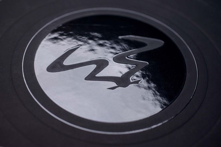 Gloss varnish combined with embossing to literally elevate the design.