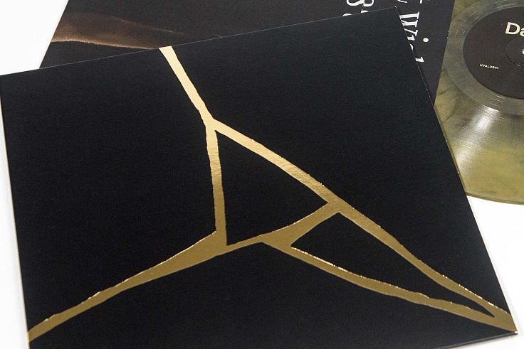 The Sam Slater cover design takes the simplified fractured shapes and adds debossing and gold.