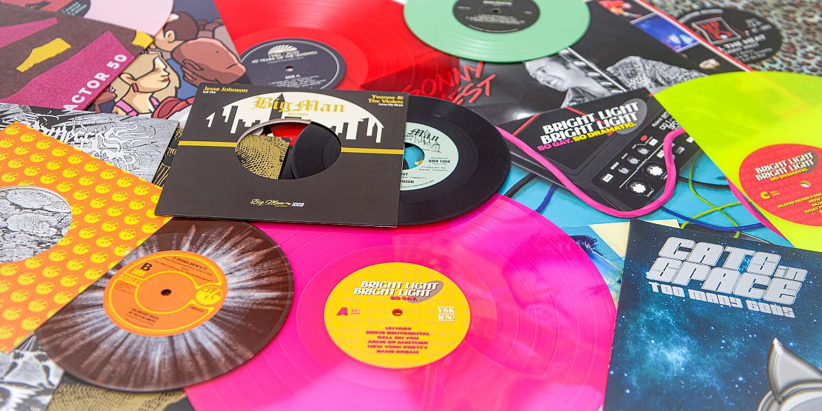 Colourful vinyl records and sleeves
